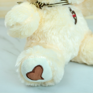 URSO DE PELUCIA DE POLIESTER COM LAÇO 25CM - FE6918-CREME